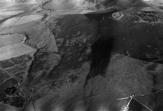 Oblique aerial view centred on the remains of the fort at White Caterthun, looking to the NE.
