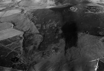 Oblique aerial view centred on the remains of the fort at White Caterthun, looking to the NE.