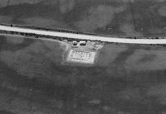 Oblique aerial view centred on the excavation of the timber hall at Balbridie, looking to the S.