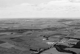 General oblique aerial view centred on the village of Drumoak, the A93 and the surrounding plantations, looking to the ENE.