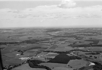 General oblique aerial view centred on the village of Drumoak, the River Dee, the A93 and the surrounding plantations, looking to the NE.