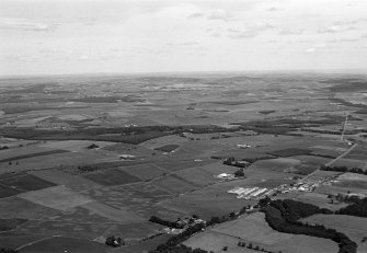 General oblique aerial view centred on the village of Drumoak, the A93 and the surrounding plantations, looking to the NNE.