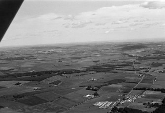 General oblique aerial view centred on the village of Drumoak, the A93 and the surrounding plantations, looking to the NE.