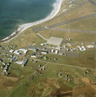 Oblique aerial view centred on Balivanich village with Benbecula airfield adjacent, taken from the S.