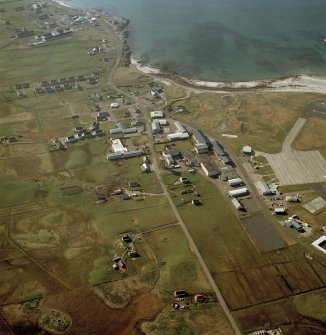 Oblique aerial view centred on Balivanich village with Benbecula airfield adjacent, taken from the SE.