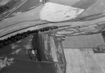 Oblique aerial view centred on the cropmarks of the palisaded enclosure, square and round barrows at Fisherhills with the North Water viaduct adjacent, looking to the NNE.