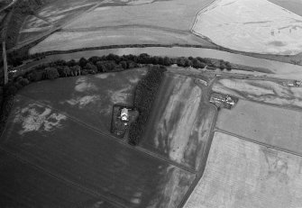 Oblique aerial view centred on the cropmarks of the palisaded enclosure, square and round barrows at Fisherhills with the North Water viaduct adjacent, looking to the NNE.