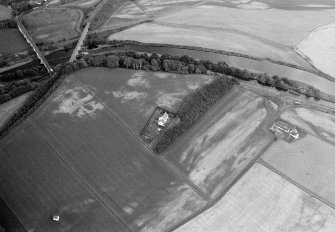 Oblique aerial view centred on the cropmarks of the palisaded enclosure, square and round barrows at Fisherhills with the North Water viaduct adjacent, looking to the NNW.