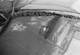 Oblique aerial view centred on the cropmarks of the palisaded enclosure, square and round barrows at Fisherhills with the North Water viaduct adjacent, looking to the NNW.