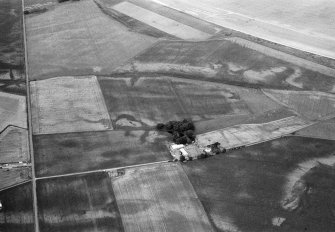 Oblique aerial view centred on the cropmarks of the unenclosed settlement, rectilinear enclosures, souterrains, barrows, ring ditches, linear features and pits at Newbarns, looking to the NNE.