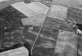 Oblique aerial view centred on the cropmarks of the unenclosed settlement, souterrain, ring ditches, linear features and pits at Newbarns Smithy, looking to the N.