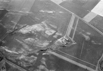 Oblique aerial view centred on the cropmarks of the possible enclosure and linear features at Crowhillock with the farmstead adjacent, looking to the WNW.