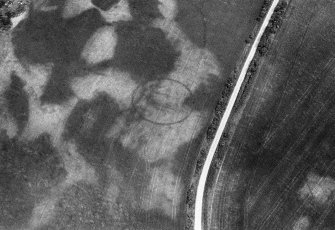 Oblique aerial view centred on the cropmarks of the unenclosed settlement, enclosure and pits at Monboddo House, looking to the ESE.