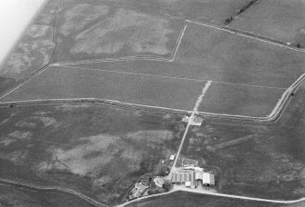 Oblique aerial view centred on the cropmarks of the unenclosed settlement, enclosure and souterrains at Myreside, looking to the NW.