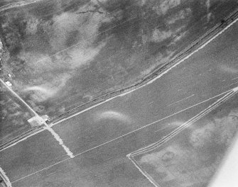 Oblique aerial view centred on the cropmarks of the unenclosed settlement, enclosure and souterrains at Myreside, looking to the E.