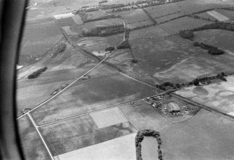 Oblique aerial view centred on the cropmarks of the unenclosed settlement, linear features and pits at Gilrivie and Pugeston, looking to the WSW.