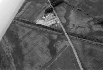 Oblique aerial view centred on the cropmarks of the Roman Temporary Camp, linear features, enclosure, pits and rig at Gilrivie with the farmstead adjacent, looking to the WNW.