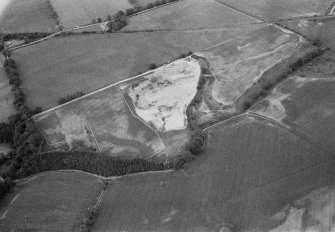 Oblique aerial view centred on the cropmarks of the unenclosed settlement, ring ditches, souterrain, pit alignment, rig and linear features at Arrat's Mill, looking to the NNE.