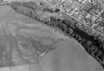 Oblique aerial view centred on the cropmarks of the pit defined cursus, pits, pit alignment and rig at Milton and Friockheim, looking to the ESE.