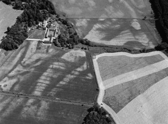 Oblique aerial view centred on the cropmarks of the enclosures, pits and rig at Balbridie, looking to the ENE.