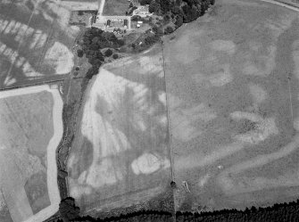 Oblique aerial view centred on the cropmarks of the enclosures, pits and rig at Balbridie, looking to the NNW.