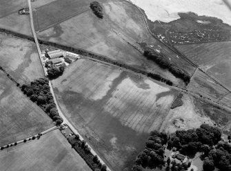 Oblique aerial view centred on the cropmarks of the enclosure,  linear features, Roman temporary camp, pits and rig with the farm adjacent at Gilrivie and Dun, looking to the ESE.