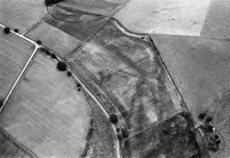 Oblique aerial view centred on the cropmarks of the sub-rectilinear enclosure at Dalsack, looking to the ESE.