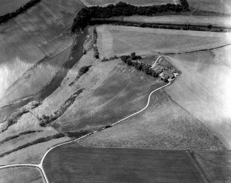 Oblique aerial view centred on the cropmarks of the enclosures and field system with the farmhouse and chapel adjacent at Chapeltown, looking to the WSW.