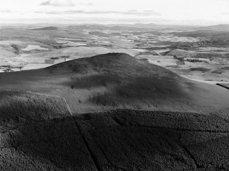 Oblique aerial view centred on the remains of the vitrified fort at Tap O' Noth, looking to the SW.