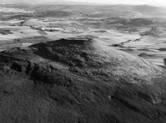 Oblique aerial view centred on the remains of the vitrified fort at Tap O' Noth, looking to the SW.
