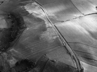 Oblique aerial view centred on the cropmarks of the circular enclosure at Barflat, looking to the SW.