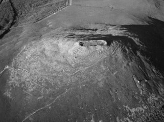 Oblique aerial view centred on the remains of the vitrified fort at Tap O' Noth, looking to the NE.