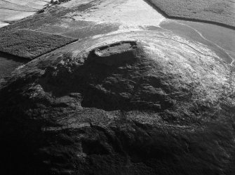 Oblique aerial view centred on the remains of the vitrified fort at Tap O' Noth, looking to the S.