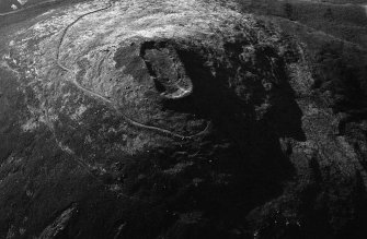 Oblique aerial view centred on the remains of the vitrified fort at Tap O' Noth, looking to the N.