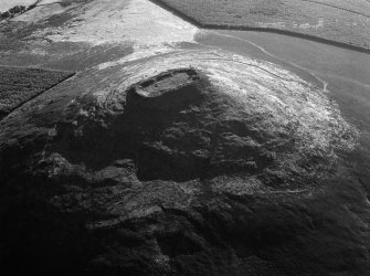 Oblique aerial view centred on the remains of the vitrified fort at Tap O' Noth, looking to the SSW.