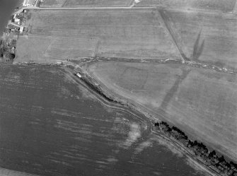 Oblique aerial view centred on the cropmarks of the enclosures  at Chapel Knap, looking to the NE.