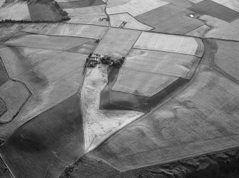 Oblique aerial view centred on the cropmarks of the unenclosed settlement, ring ditches, souterrains, enclosure, linear features, rig and pits at Newbarns, looking to the WNW.