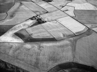 Oblique aerial view centred on the cropmarks of the unenclosed settlement, ring ditches, souterrains, enclosure, linear features, rig and pits at Newbarns, looking to the W.