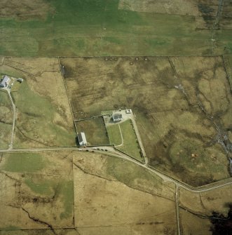 Oblique aerial view centred on the church and manse, taken from the NW.