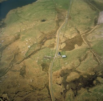 Oblique aerial view centred on the farmstead and the remains of the buildings, taken from the E.