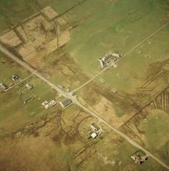 Oblique aerial view centred on part of the crofting township and the church with the remains of the crofting township adjacent, taken from the ESE.