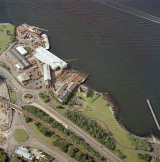 Oblique aerial view centred on the castle and shipyard, taken from the SE.