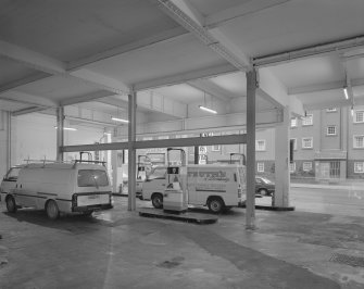 Scanned copy of view of the interior of the garage forecourt in use as a filling station seen from its North East corner.