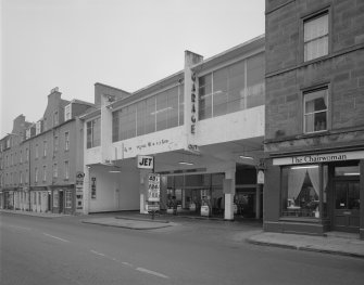 Scanned copy of general view of the front of the garage from the South West, in use as a filling station with the upper floor in disrepair.