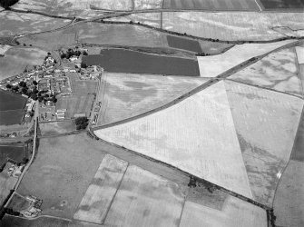 General oblique aerial view of the roughly circular enclosure, looking to the NW.