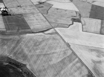 Oblique aerial view of the cropmarks of the unenclosed settlement at Newbarns, looking to the WSW.
