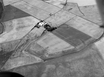 Oblique aerial view centred on the cropmarks of the unenclosed settlement, ring ditches, souterrains, enclosure, linear features, rig and pits at Newbarns, looking to the WSW.