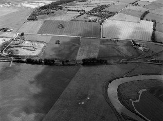 General oblique aerial view centred on the remains of the stone circle, cropmarks of ring ditches and rig at Fullerton, looking to the SSW.
