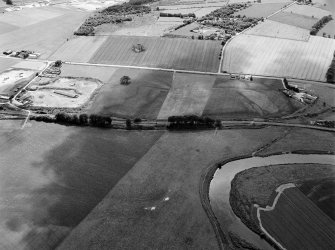 General oblique aerial view centred on the remains of the stone circle, cropmarks of ring ditches and rig at Fullerton, looking to the SSW.