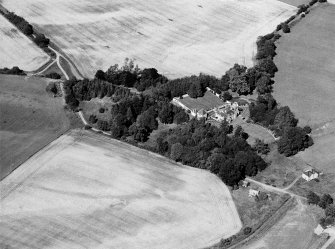 Oblique aerial view of Tarradale House with the cropmarks adjacent, looking to the NE.